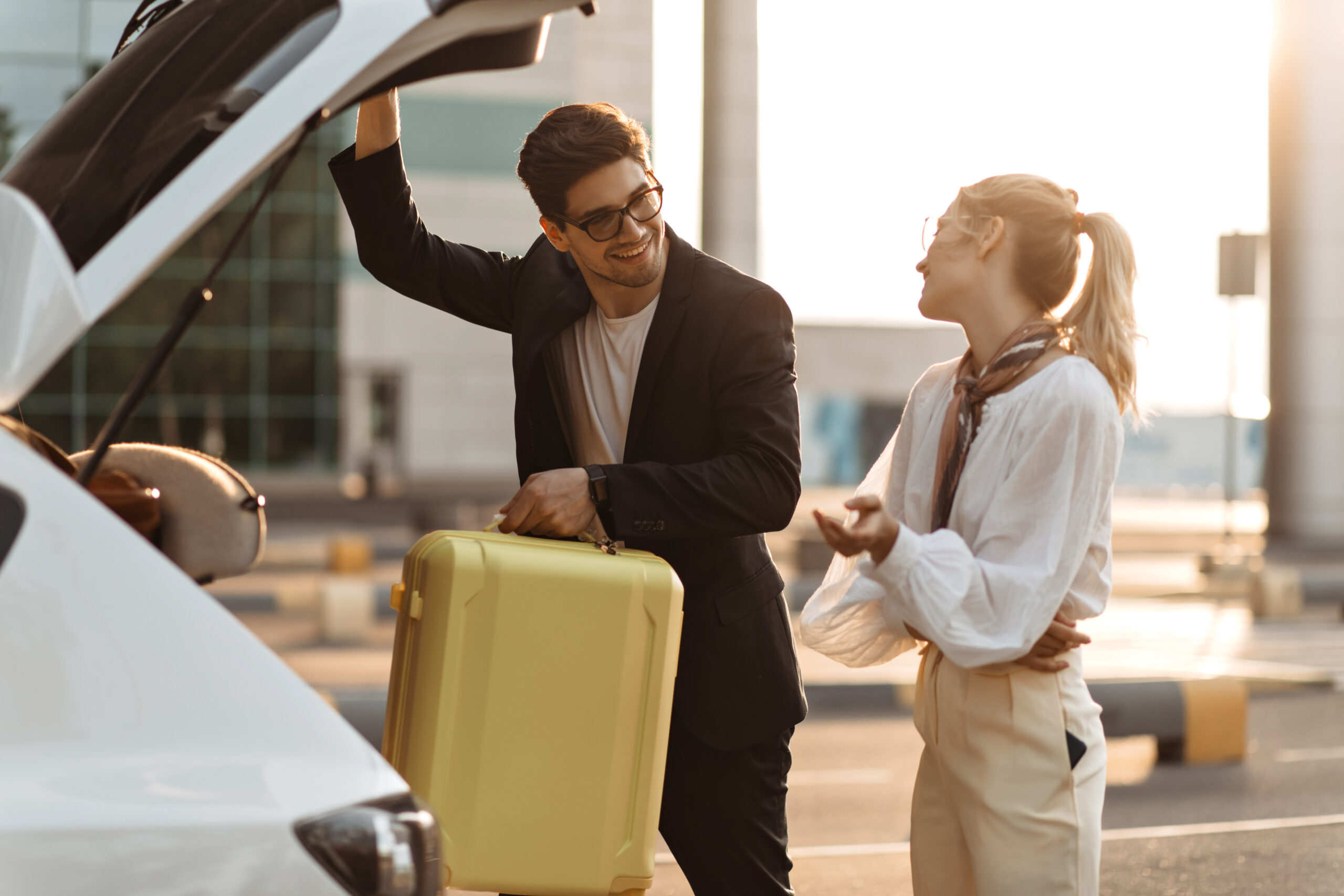 Charming,Brunette,Man,In,Sunglasses,,Black,Suit,Looks,At,Girlfriend MCI airport parking