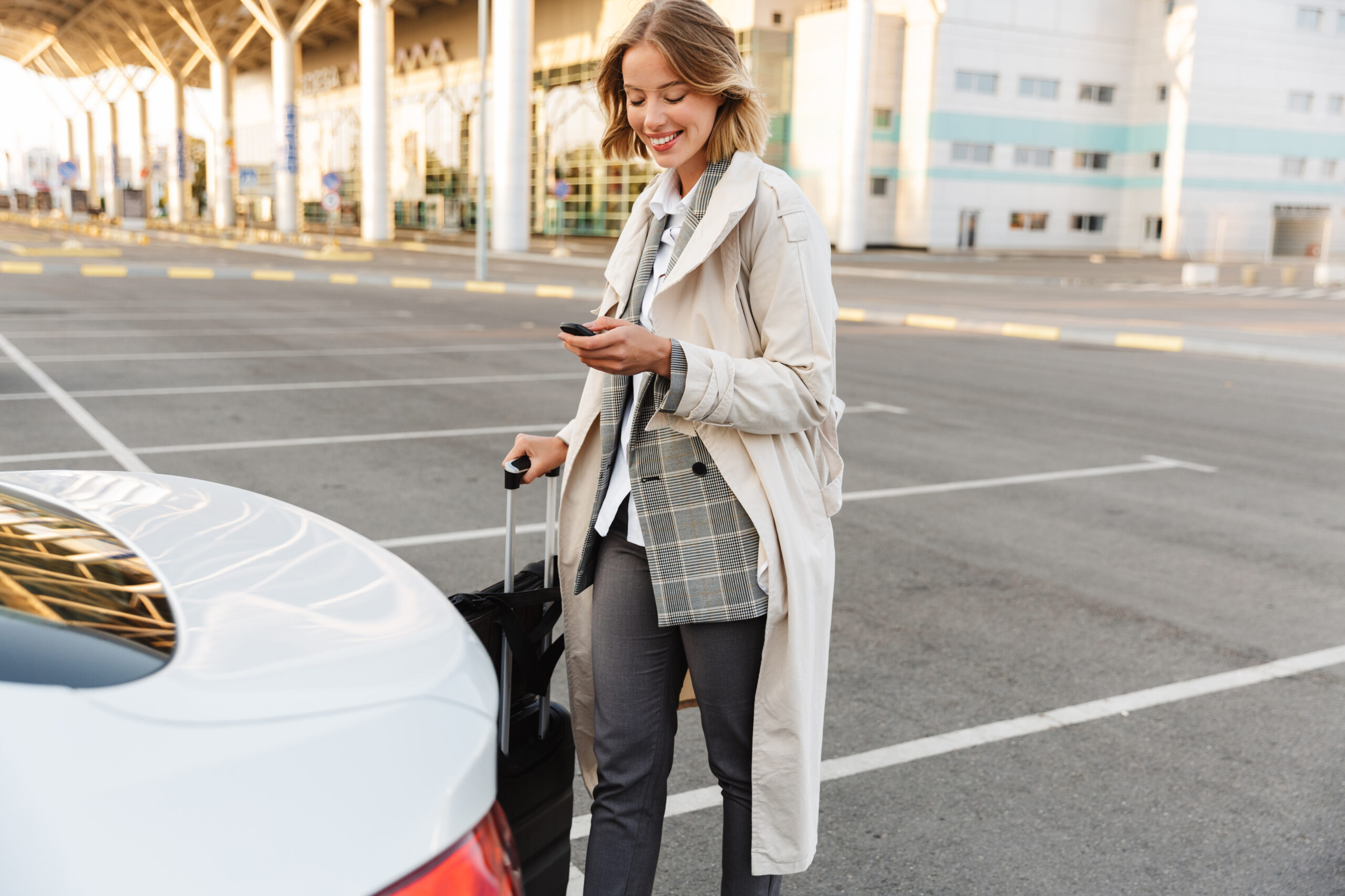 Photo,Of,Young,Smiling,Businesswoman,In,Formal,Wear,Standing,With Trueparkings: Kansas City International Airport (KCI/MCI)|Kansas City Airport Parking Advantages